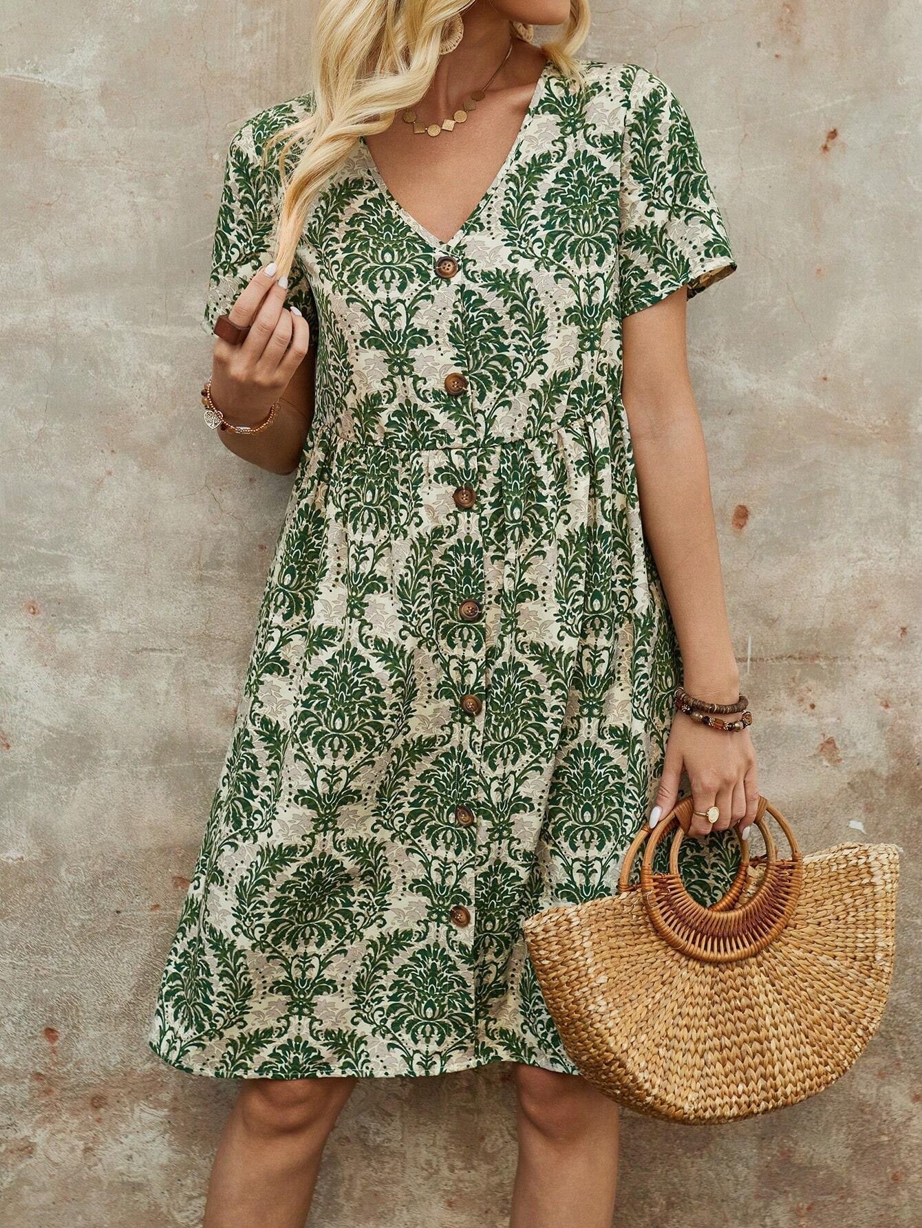 Woman with blonde hair in a green and white floral print midi dress, V-neck, short sleeves, holding a straw handbag.