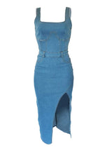 Front view of a blue denim midi dress with a square neckline and a high slit.