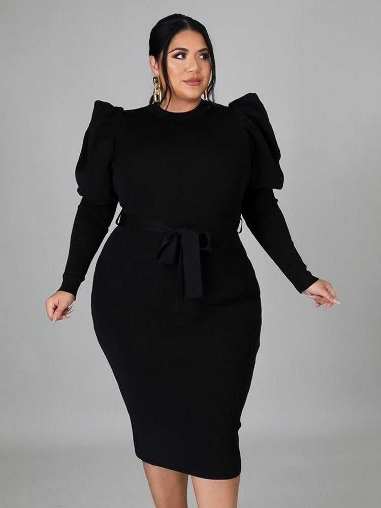 Front view of a woman in a black puff sleeve midi dress