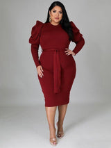 Model in a burgundy midi dress with puff sleeves and a self-tie belt