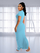 Back view of a woman in a light blue ruched maxi dress