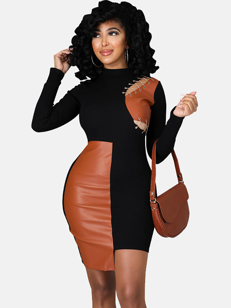 Woman wearing a black and brown faux leather color-blocked bodycon dress with a mock neck and chain detailing on the shoulder.