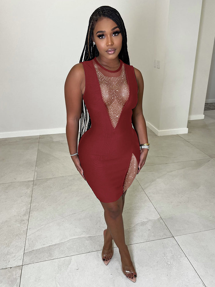 Woman wearing a red sleeveless bodycon dress with sheer mesh neckline and high slit embellished with rhinestones