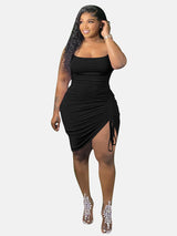 A black bodycon dress with ruching and a side slit, modeled by a woman.