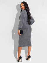 Rear view of a woman in a silver metallic knit V-neck long sleeve bodycon midi dress