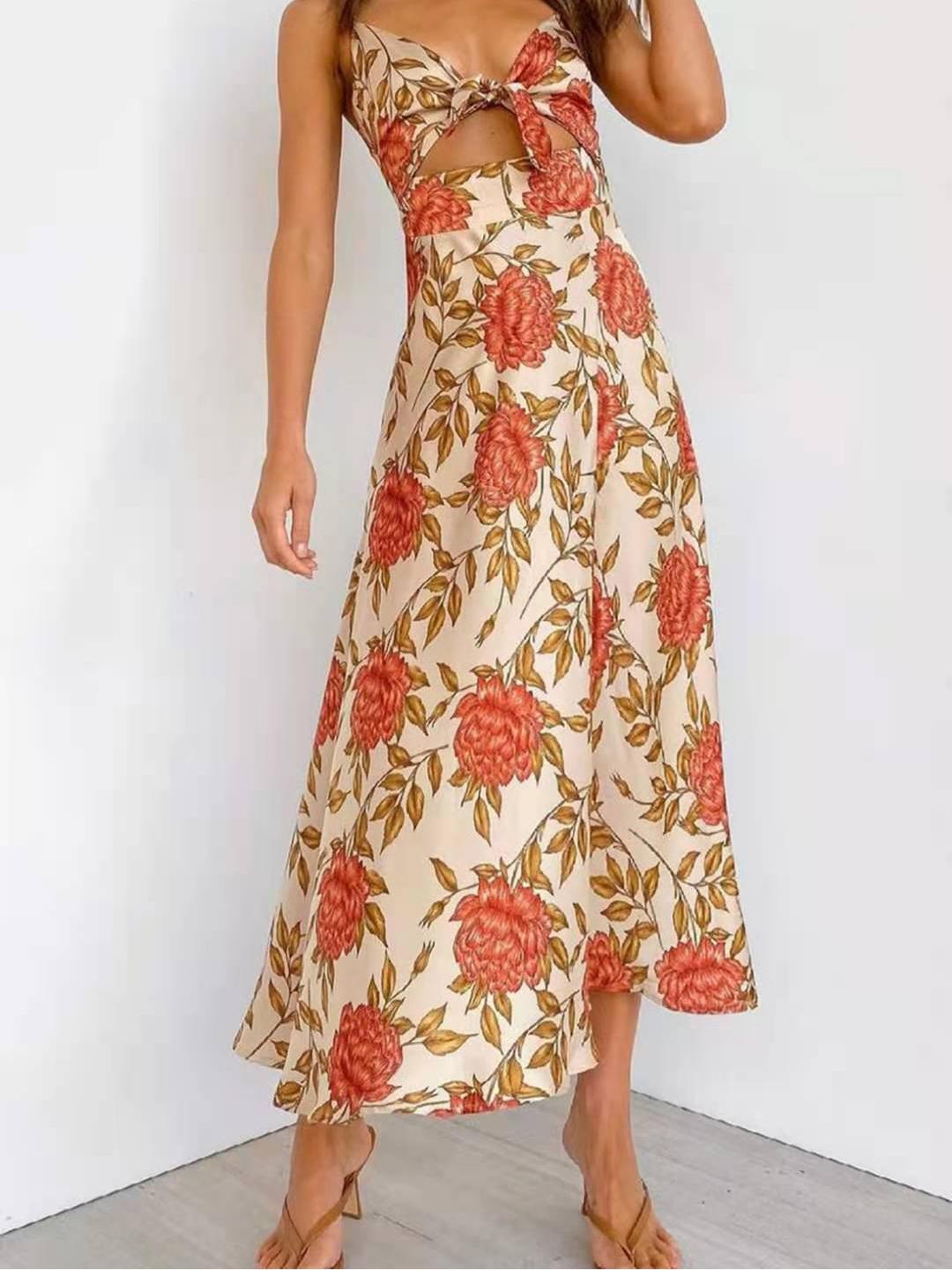 Woman wearing a floral print satin dress with a cut-out and thigh-high slit, standing with her arms at her sides.
