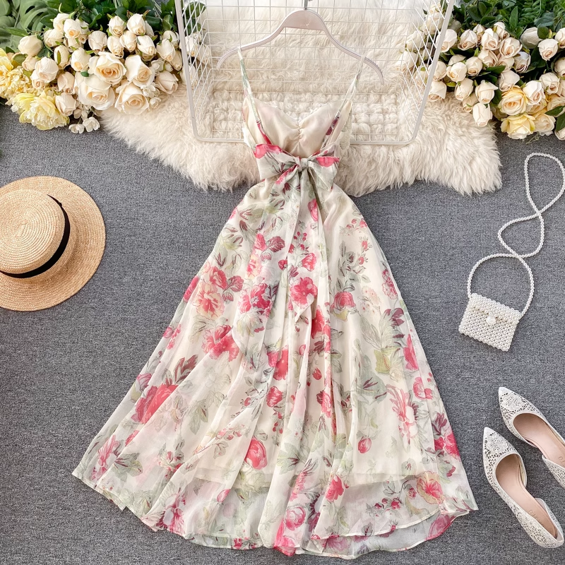 The back of the floral print midi dress, revealing a bow detail at the waist.