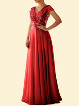 Woman wearing a red sequined formal dress with a flowing skirt