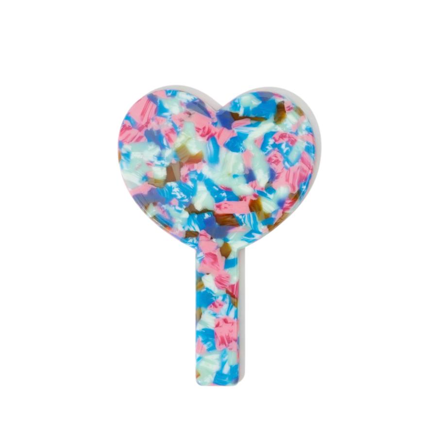 A heart-shaped hand mirror with a colorful marbled pattern on a white background.