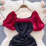 Close-up of the square neckline and puff sleeves of the dress