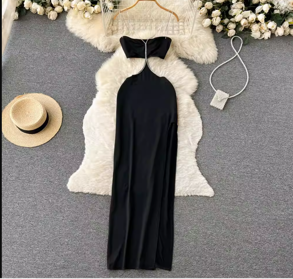 Black maxi dress with a halter neckline and high slit, shown flat lay with accessories.