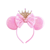 Pink sequin Minnie Mouse ears headband with a gold crown and pink bow