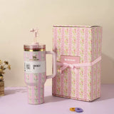 Pink floral Stanley 40oz insulated tumbler with straw and matching gift box, vertical rose stripe design