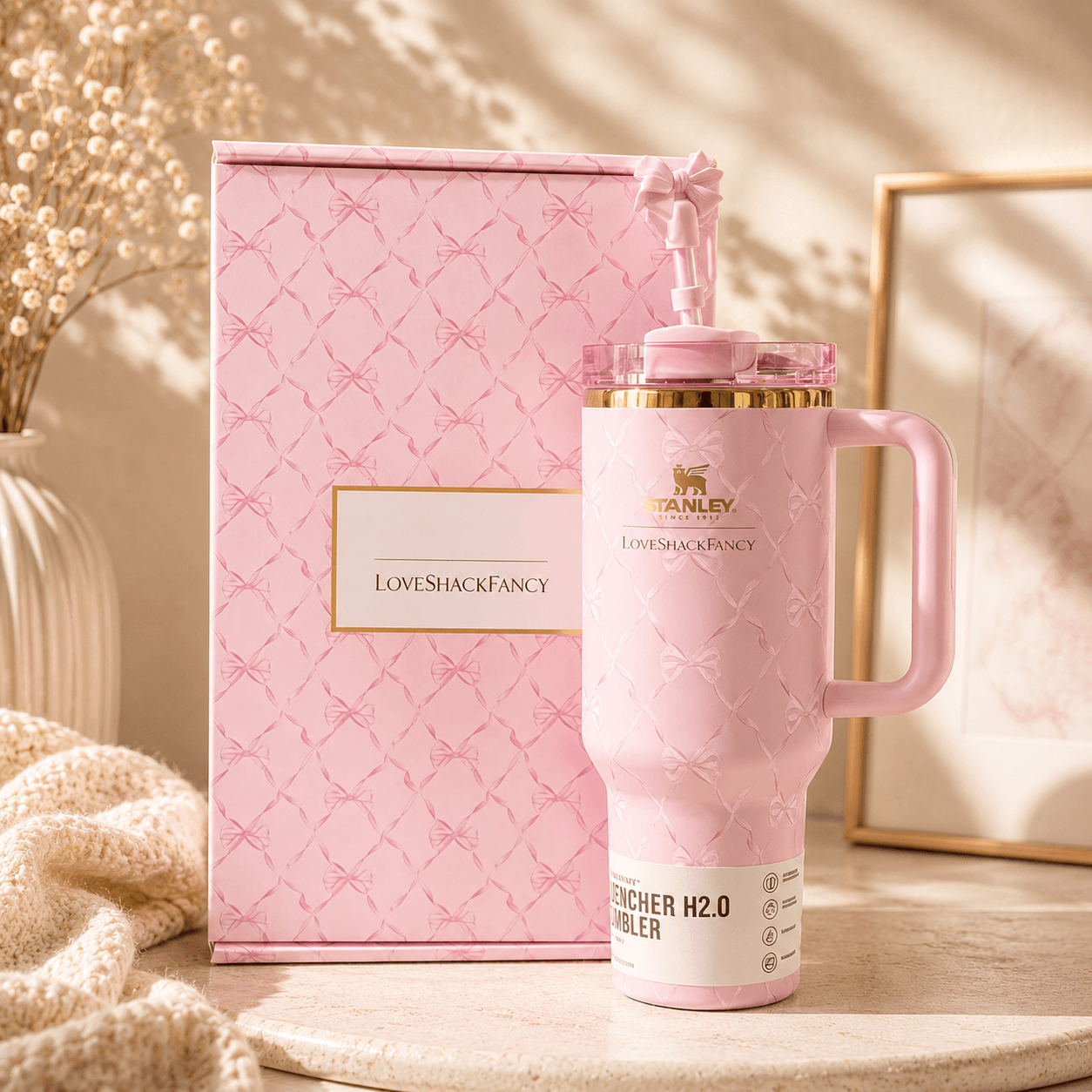 Pink water bottle with handle and matching box on a neutral background