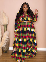 Woman posing in a colorful plaid maxi dress