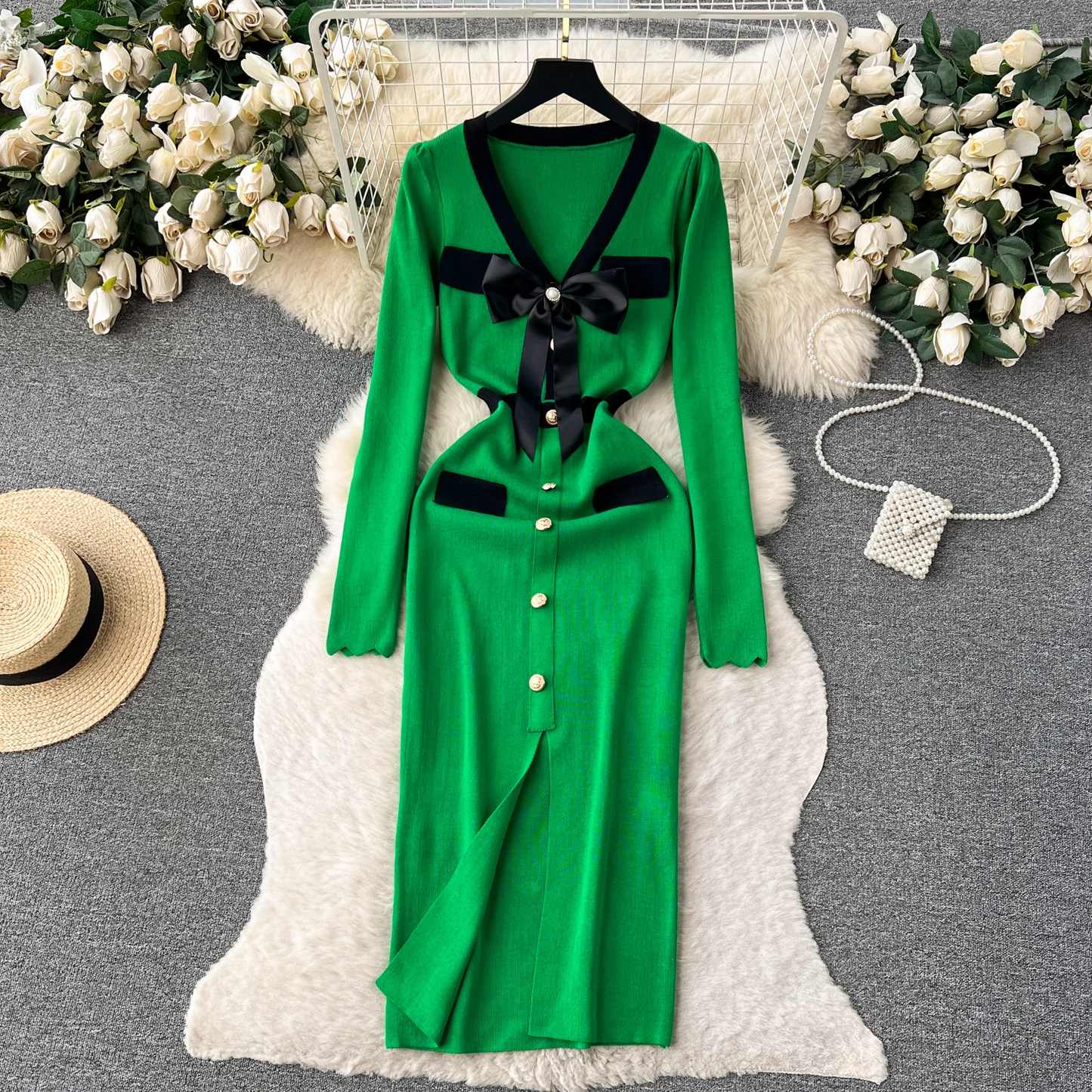 Green knit dress with black trim and bow detail