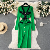 Green knit dress with black trim and bow detail