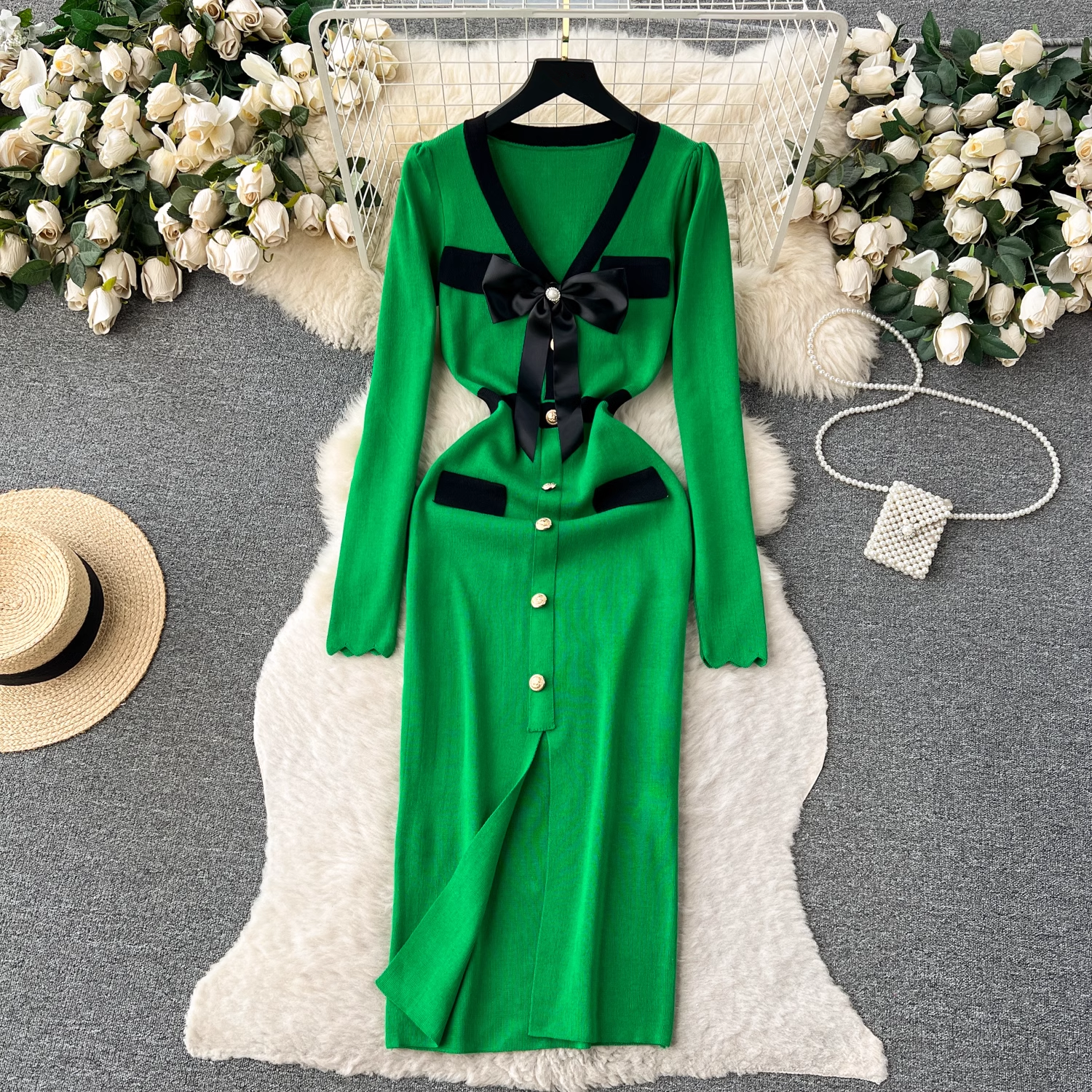 Green knit dress with black trim and bow detail