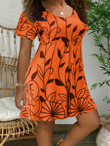 woman wearing an orange floral print short sleeve a-line dress