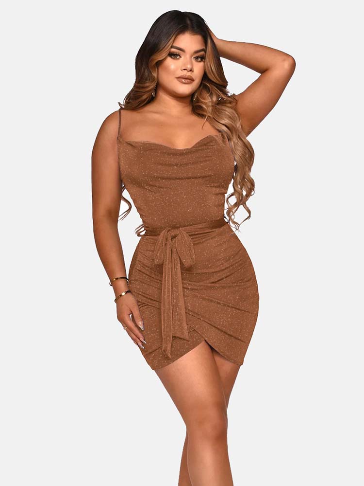 Woman wearing a short brown sparkly dress with a cowl neckline and spaghetti straps, tied at the waist with a matching belt, against a white background.
