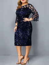 Woman wearing a navy blue sequined sheath dress with sheer geometric mesh bell sleeves