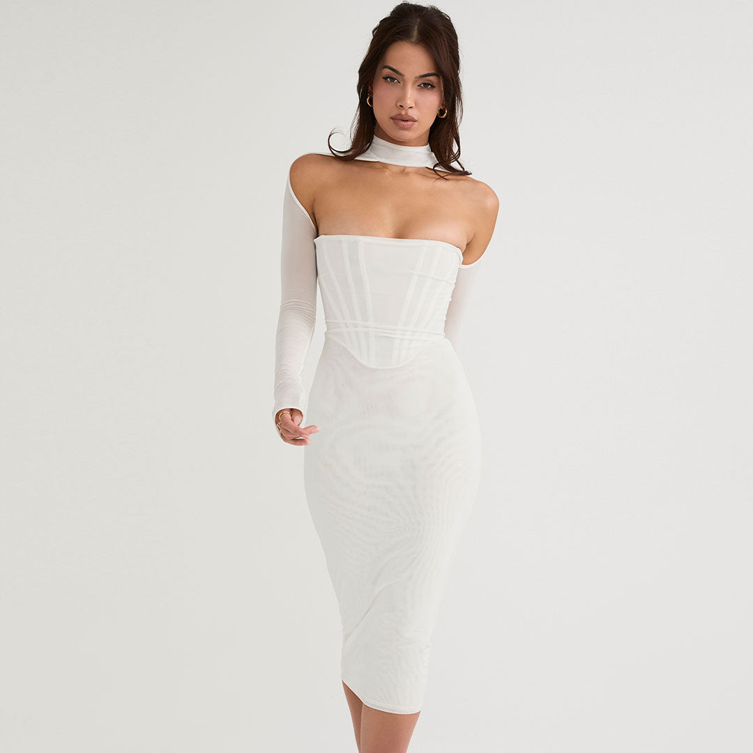 Full-length view of a woman in a white sheer long-sleeve midi dress with a corset bodice and choker neckline.