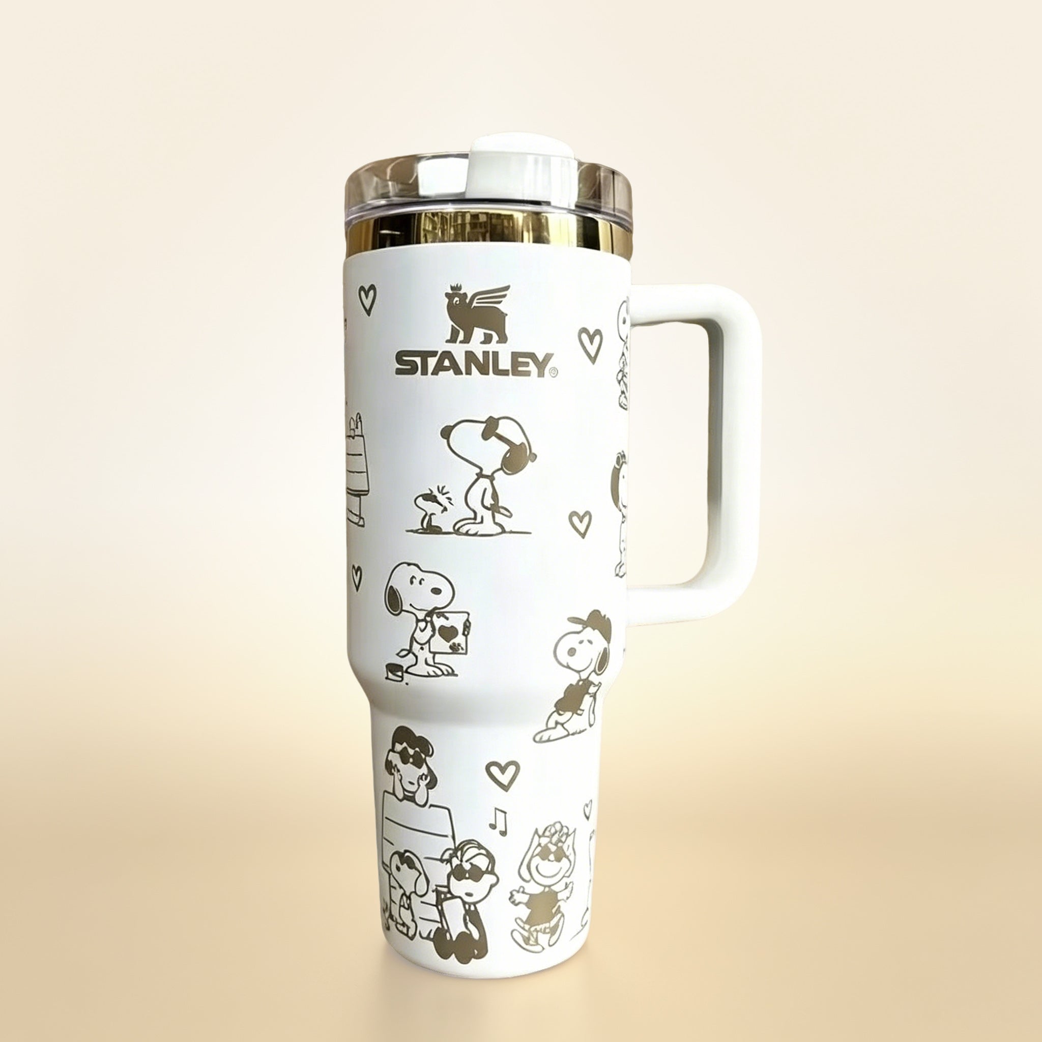 Stanley 40oz insulated tumbler with Snoopy and Woodstock illustrations, hearts and playful icons, white ergonomic handle