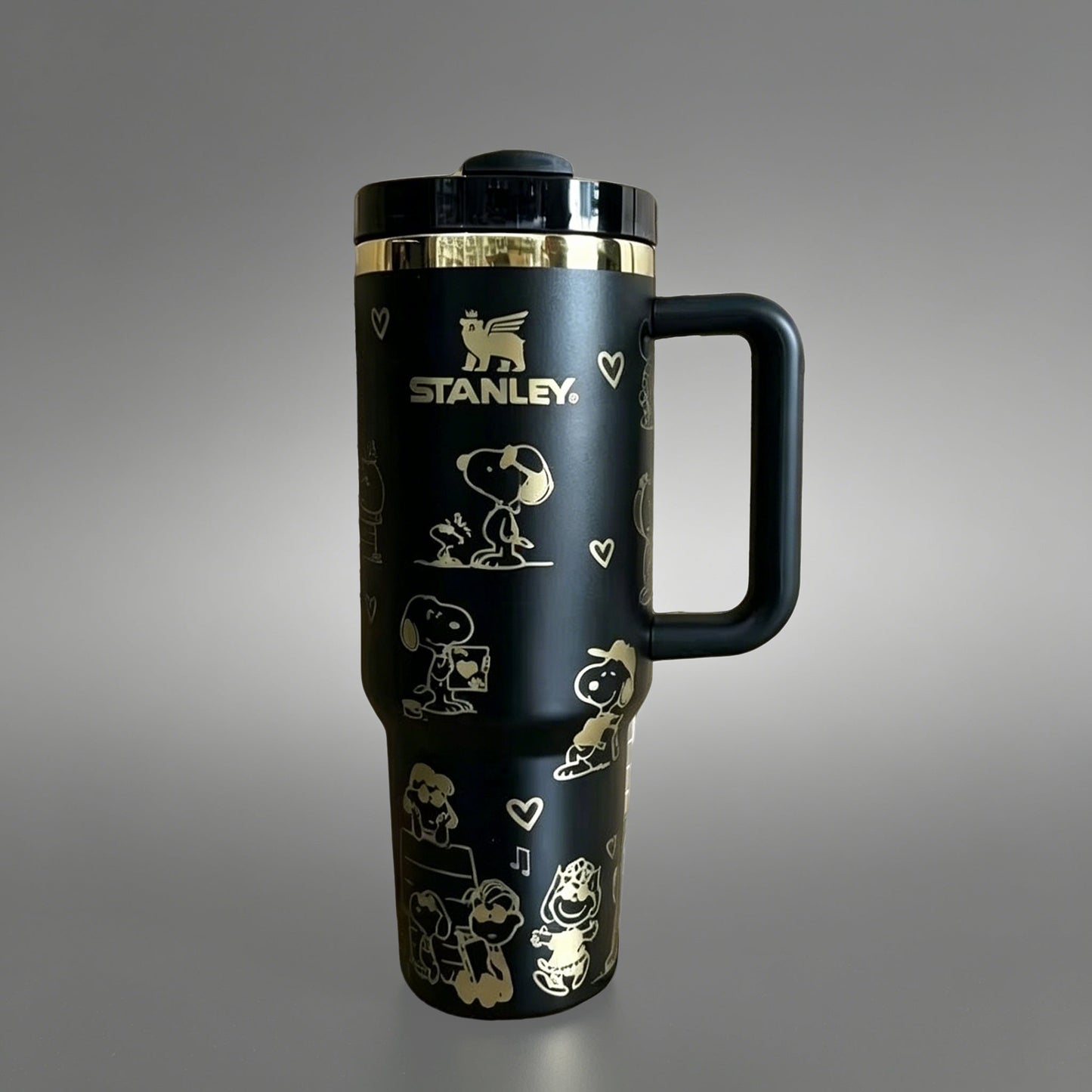 Stanley 40oz insulated tumbler with Snoopy and Woodstock illustrations, hearts and playful icons, white ergonomic handle