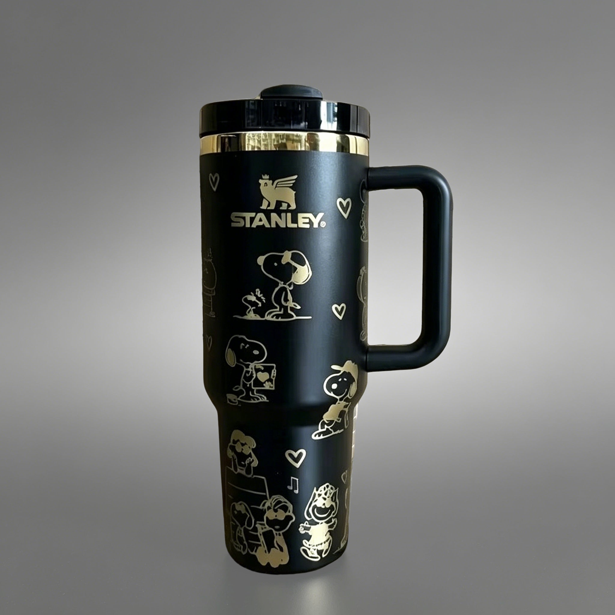 Stanley 40oz insulated tumbler with Snoopy and Woodstock illustrations, hearts and playful icons, white ergonomic handle