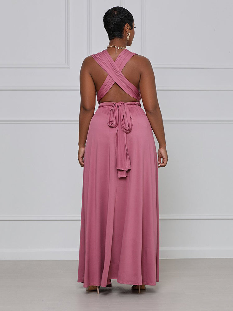 Back view of a woman wearing a dusty rose maxi dress with a criss-cross back.