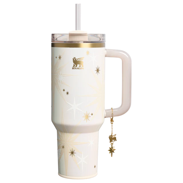 Stanley 40oz insulated tumbler featuring celestial star pattern, gold accents, hanging star charm, and cream ergonomic handle