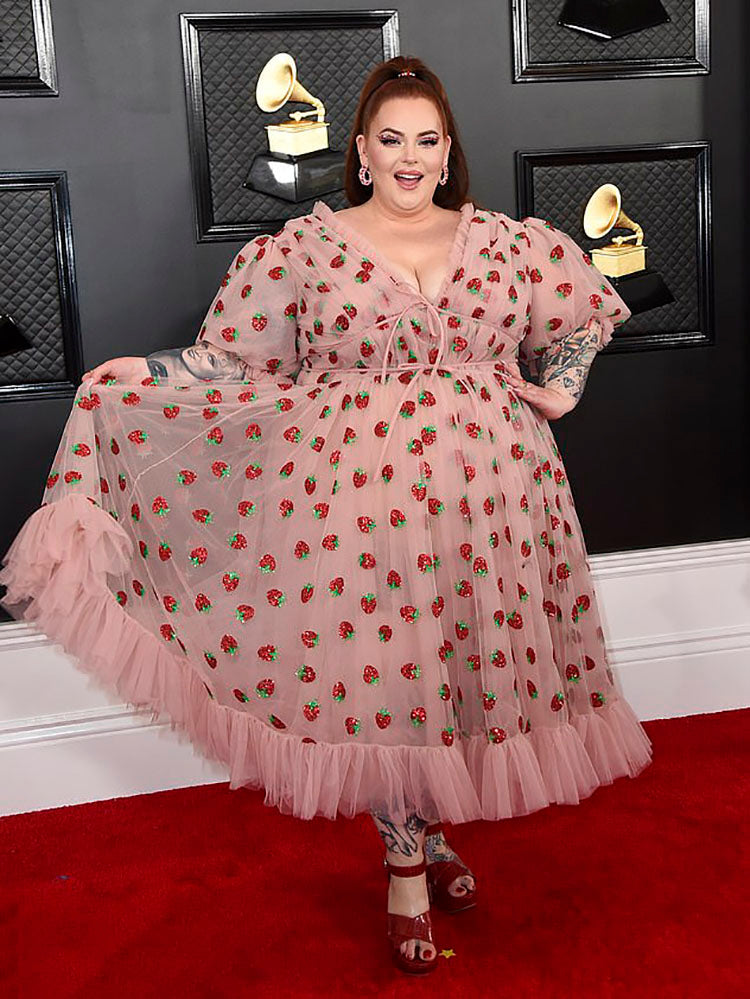 Woman in strawberry print dress on red carpet