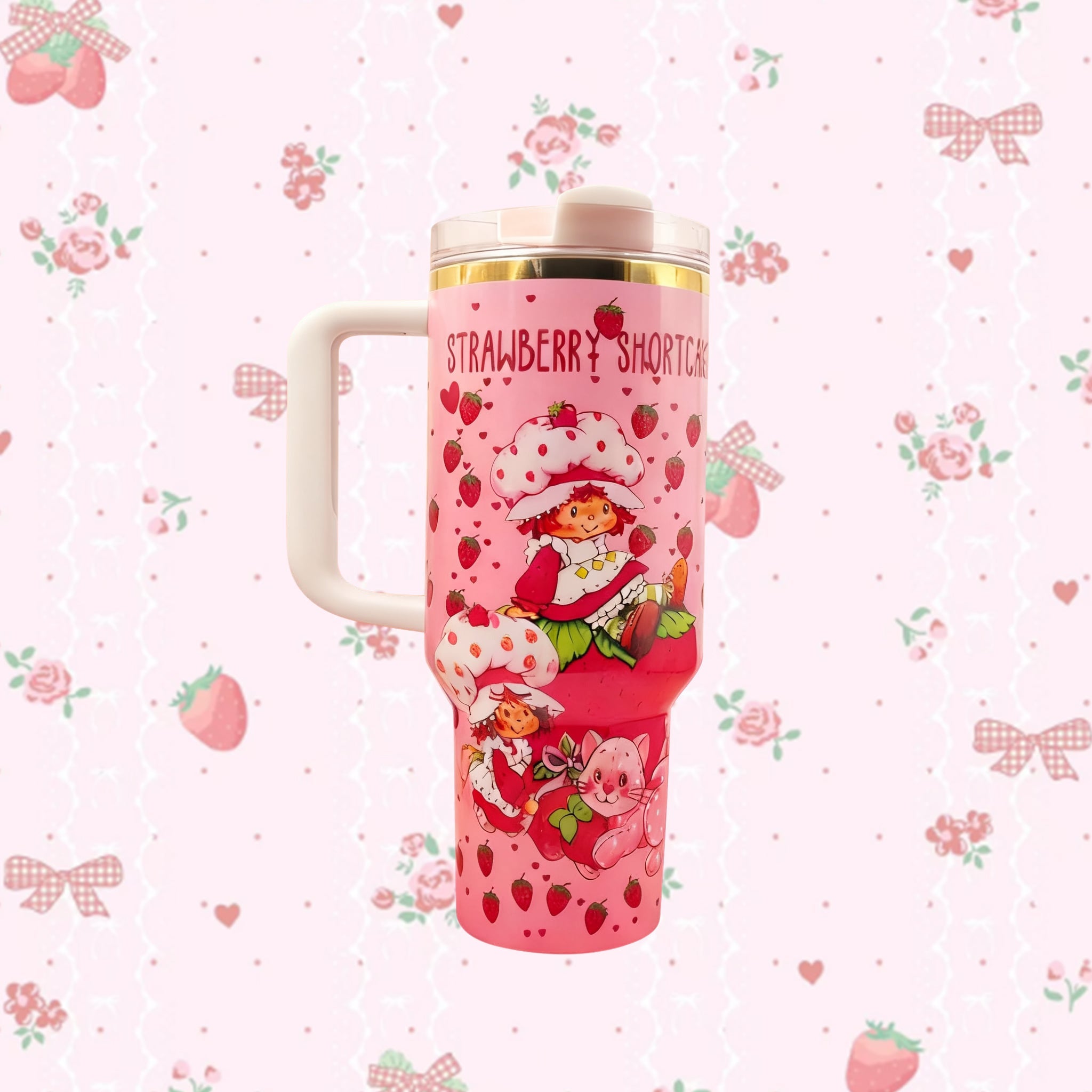 Stanley 40oz insulated tumbler featuring Strawberry Shortcake artwork, pink strawberry pattern, white handle and floral background