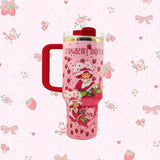 Stanley 40oz insulated tumbler featuring Strawberry Shortcake artwork, pink strawberry pattern, white handle and floral background