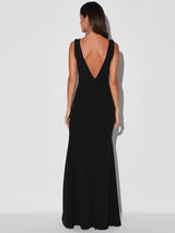 Back view of a woman in a black maxi dress with a deep V-back.
