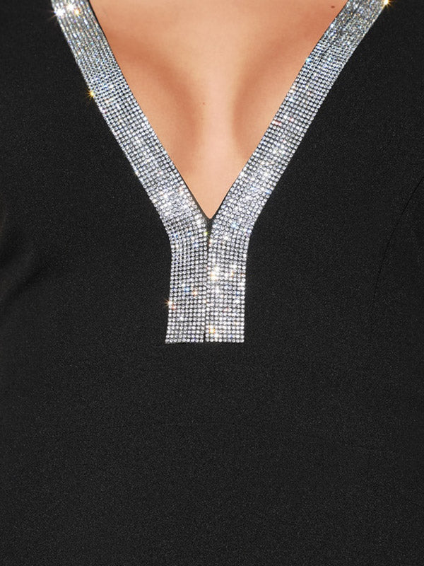 Detailed view of the rhinestone embellishment on the V-neckline of a black dress.