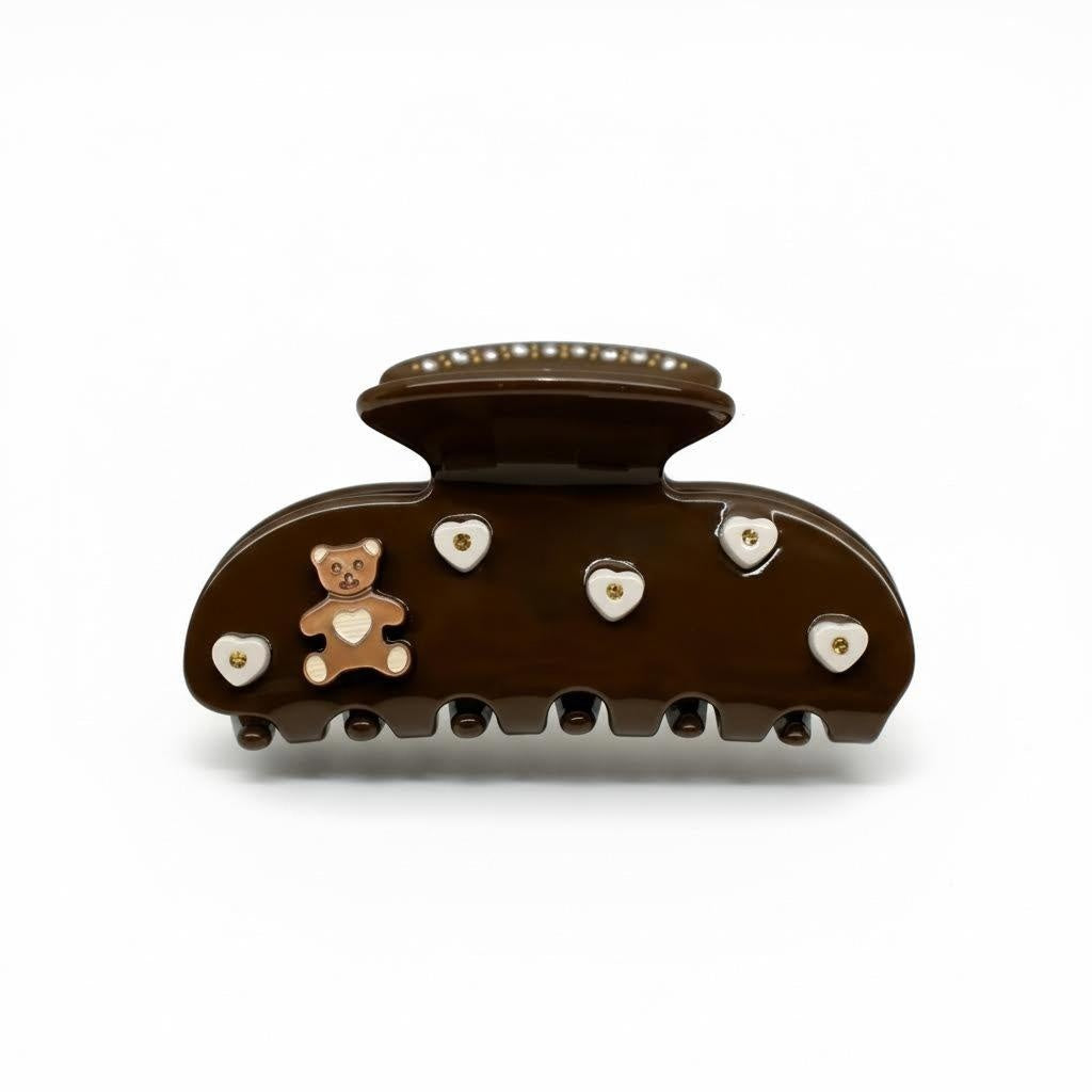 Brown teddy bear hair claw clip with white heart details and pearl accents