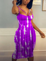 Woman in a purple and white tie-dye midi dress, side view.