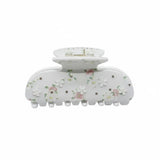 White floral claw hair clip with pink and white flowers and rhinestones