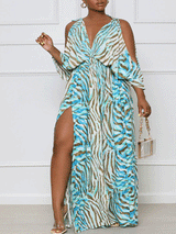 Woman wearing a blue and brown animal print maxi dress with a V-neck and cold-shoulder sleeves, standing and showing the front of the dress.
