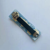 The underside of the barrette showing the metal clasp mechanism.