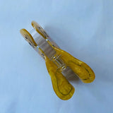 Top view of a yellow marbled acrylic dog-shaped hair clip