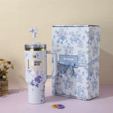 White and blue floral Stanley 40oz insulated tumbler with straw and matching gift box, elegant purple flowers design