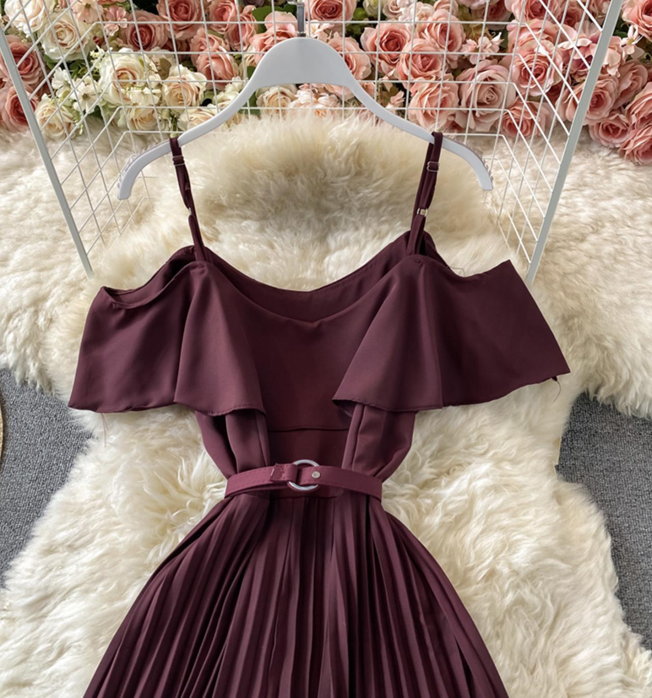 Close-up of the ruffled neckline and belt on a burgundy dress