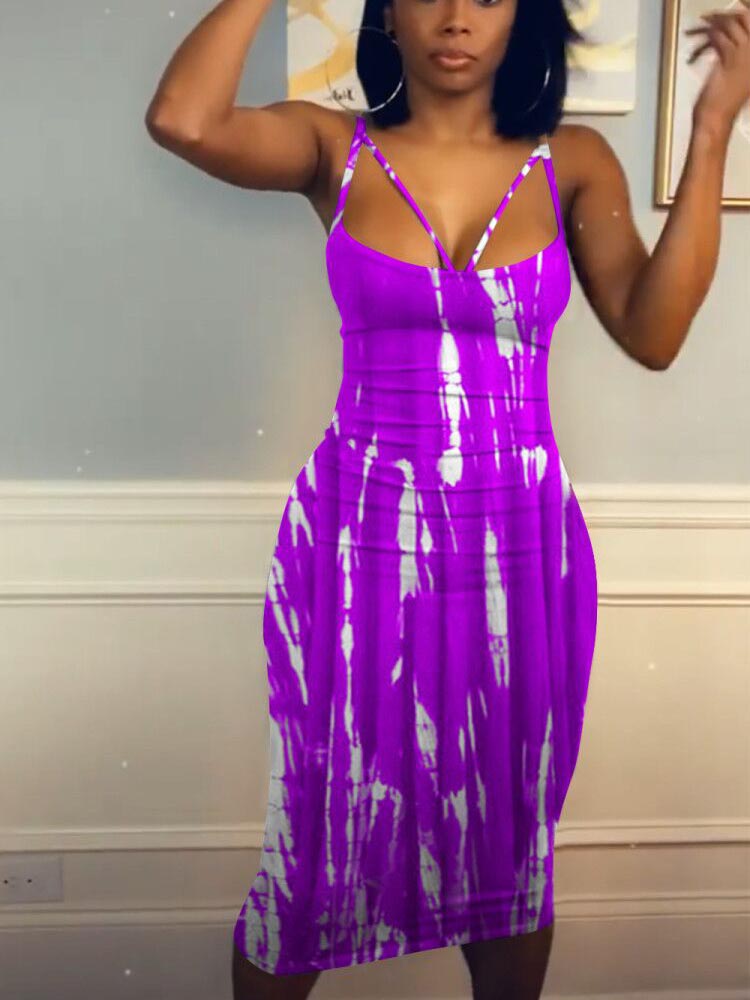 Woman wearing a purple and white tie-dye midi dress with spaghetti straps.
