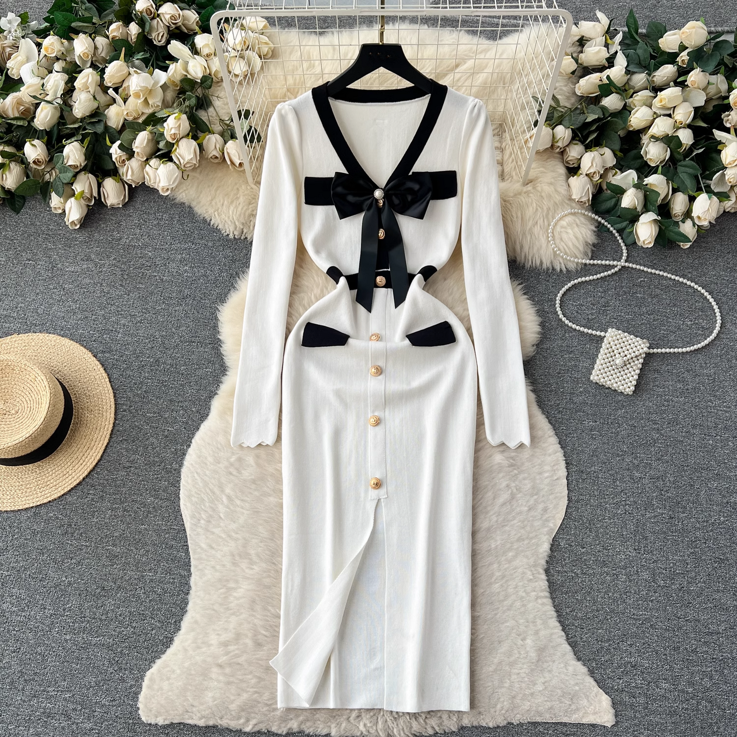 White knit dress with black trim and bow detail