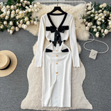 White knit dress with black trim and bow detail