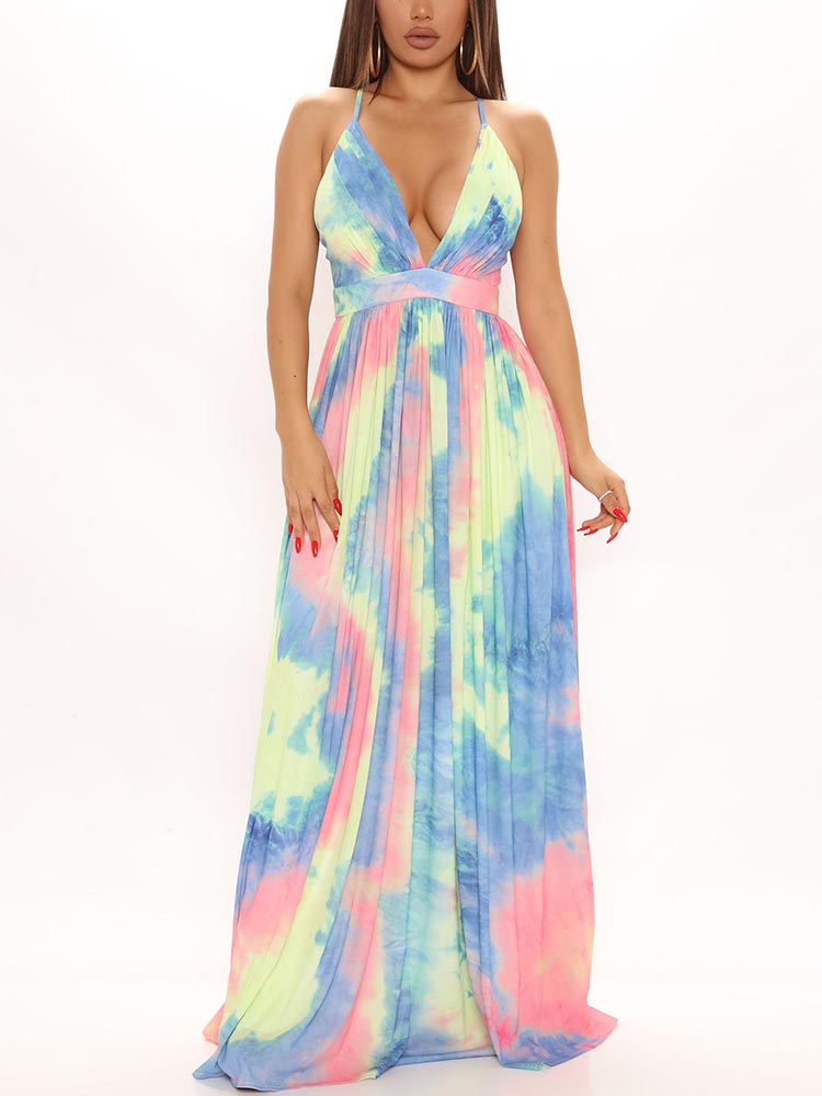 Woman wearing a flowing maxi dress with a tie-dye print in shades of blue, pink, and lime green.