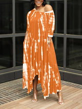 Woman wearing an orange tie-dye maxi dress with an asymmetrical hem and three-quarter sleeves, standing outdoors.