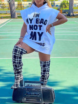 Woman wearing a white hooded mini dress with a graphic print, paired with houndstooth pattern knee-high boots, posing on a tennis court with a boombox.